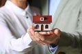 Young couple holding house model, closeup Royalty Free Stock Photo