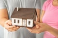 Young couple holding house model, closeup. mortgage concept Royalty Free Stock Photo