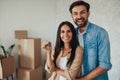 Young couple holding keys to a new house and feeling happy Royalty Free Stock Photo