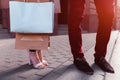 Young couple holding shopping bags after shopping on city street in summer. Closeup of purchases. Sale Royalty Free Stock Photo