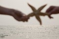 Young Couple Holding Starfish Royalty Free Stock Photo