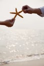 Young Couple Holding Starfish Royalty Free Stock Photo