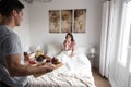 young couple at home with breakfast in bed suprise Royalty Free Stock Photo