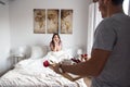 young couple at home with breakfast in bed suprise Royalty Free Stock Photo