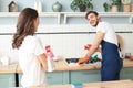 Young couple at home doing hosehold chores