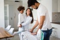 Young couple at home doing hosehold chores and ironing