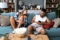 Young couple at home have a problem and argue due to jealousy caused by chatting and flirting via social media networks on smart