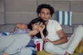 Young couple at home watching a movie with popcorn Royalty Free Stock Photo