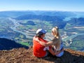 Friends hugging on mountain top with scenic views. Success. Royalty Free Stock Photo