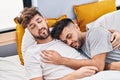 Young couple hugging each other sleeping on bed at bedrooom