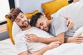 Young couple hugging each other sleeping on bed at bedrooom