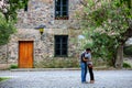 Young couple hugging in front of an old house in Colonia del Sac