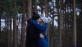 Young couple hugging and kissing in park in winter. Couple happy together. Portrait of happy meeting couple in love and Royalty Free Stock Photo