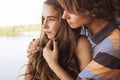 Young couple hugging in the summer daylight on a bridge construction in the city outdoors. copy space