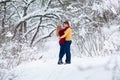 Young couple hugs in winter forest Royalty Free Stock Photo