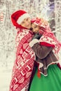 Young couple, man and woman, husband and wife are walking in costumes of flowers typical of the elves of Santa`s helpers in a win Royalty Free Stock Photo