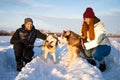 Young Couple With A Husky Dog Walking In Winter Park At Sunset Royalty Free Stock Photo
