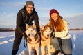 Young Couple With A Husky Dog Walking In Winter Park At Sunset Royalty Free Stock Photo