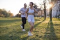 Young couple jogging in park at morning. Health and fitness. Royalty Free Stock Photo