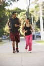 Young Couple Jogging On Street Royalty Free Stock Photo