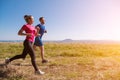 Young couple jogging on sunny day at summer mountain Royalty Free Stock Photo