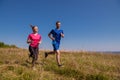 Young couple jogging on sunny day at summer mountain Royalty Free Stock Photo