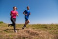 Young couple jogging on sunny day at summer mountain Royalty Free Stock Photo