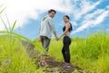 Couple jogging up stair in forest, holding hands together