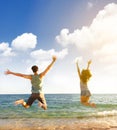 Young couple jumping on the beach Royalty Free Stock Photo