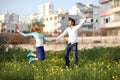 Young couple jumping in meadow Royalty Free Stock Photo