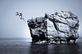Young couple jumping in sea from rock Black White Royalty Free Stock Photo