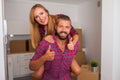 Young couple just move to their new apartment. Boy carrying girl Royalty Free Stock Photo