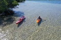 Young couple kayaking on Bear Cut off Key Biscayne, Florida on sunny afternoon.