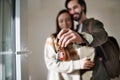 Young couple with keys moving in new flat, new home and relocation concept.