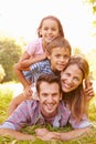 Young couple and kids having fun together outdoors Royalty Free Stock Photo