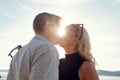 Young Couple Kissing Against Sun At Beach Royalty Free Stock Photo