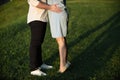 A young couple kissing in a backyard in summer sun light during sunset Royalty Free Stock Photo