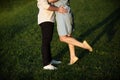 A young couple kissing in a backyard in summer sun light during sunset Royalty Free Stock Photo