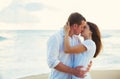Young Couple Kissing on the Beach at Sunset Royalty Free Stock Photo