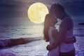 couple kissing on beach and watching the moon.Celebrate Mid autumn festival