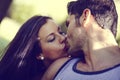 Young couple kissing in a beautiful park Royalty Free Stock Photo