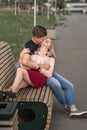 Young couple kissing at the bench on the street Royalty Free Stock Photo