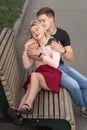 Young couple kissing at the bench on the street Royalty Free Stock Photo