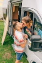 Couple kissing through the camper van window during a trip Royalty Free Stock Photo