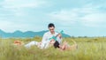 Young couple kissing in a field. asian woman hugging a caucasian man in the middle of a wheat field and kissing each other. Royalty Free Stock Photo