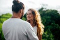 Young woman hugging asian man in the middle of a wheat field and kissing each other. Royalty Free Stock Photo