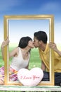 Young couple kissing with a frame Royalty Free Stock Photo
