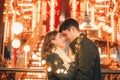 Young couple kissing and hugging outdoor in night street at christmas time Royalty Free Stock Photo