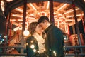 Young couple kissing and hugging outdoor in night street at christmas time Royalty Free Stock Photo