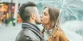 Young couple kissing in metropolis city during winter time - Lovers having tender moments on trip vacation - Love, travel and